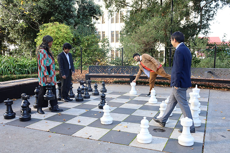 International Student Ambassadors playing chess in Franklin Square